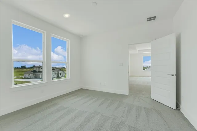 an empty room with windows and closet