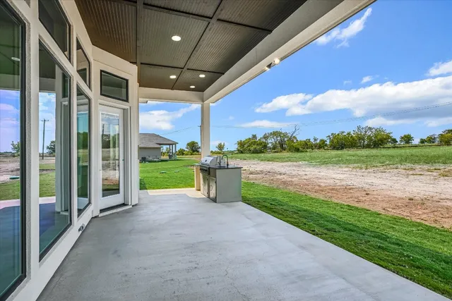 a view of a patio with a yard