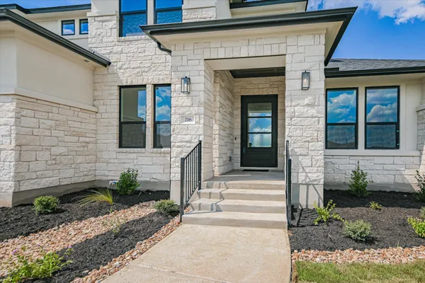 a front view of a house with a yard