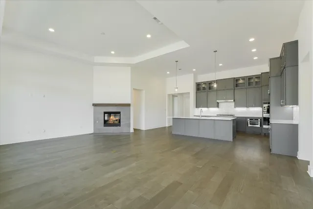 a large white kitchen with a large window