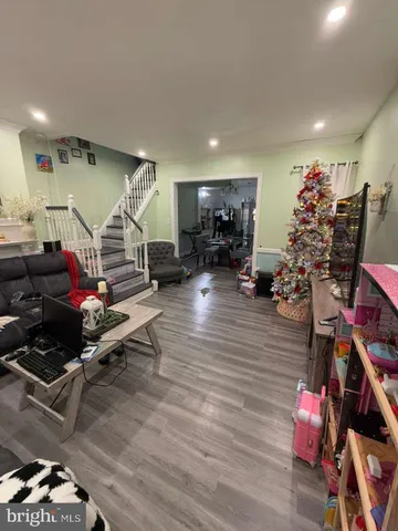 a room with lots of gym equipment and wooden floor