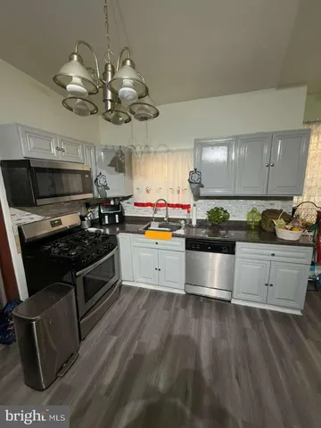 a kitchen with a stove cabinets and window