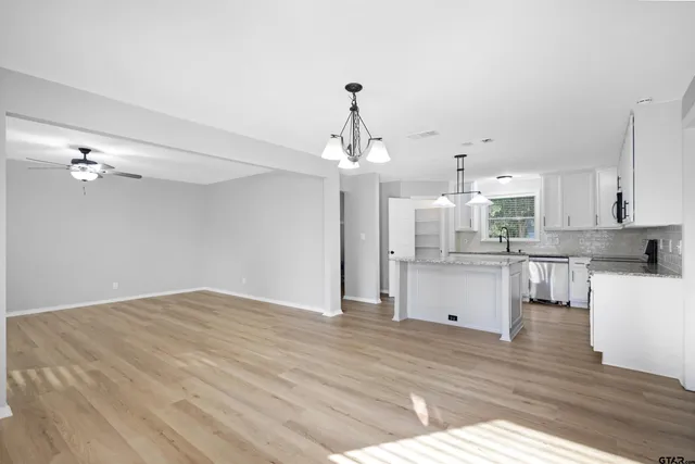 a view of kitchen with granite countertop cabinets and wooden floor