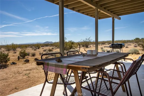 a view of an outdoor dining space with furniture