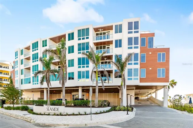a front view of a building with a garden and plants