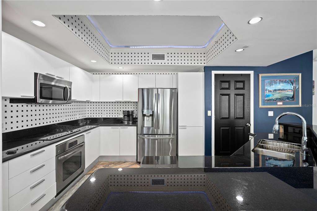 241 Riverside Drive, Unit 1909 Daytona Beach, FL 32117 - Photo 11 of 50 a kitchen with a refrigerator and a sink