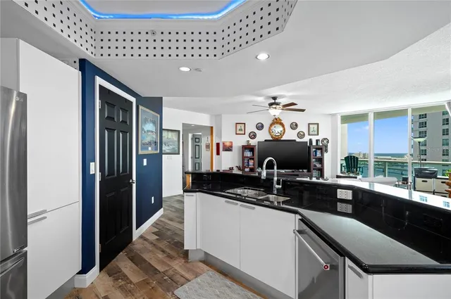 a kitchen with a sink and refrigerator