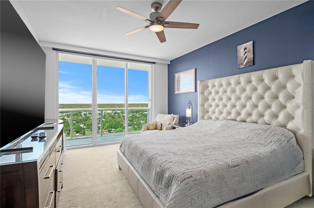 241 Riverside Drive, Unit 1909 Daytona Beach, FL 32117 - Photo 13 of 50 a bedroom with a bed and a window