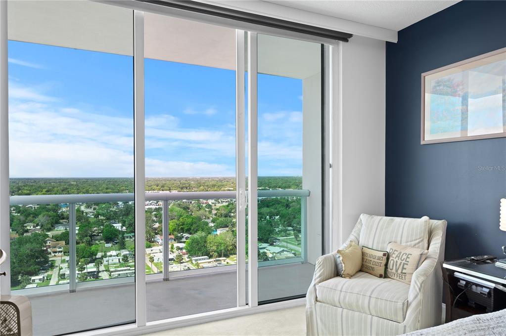 241 Riverside Drive, Unit 1909 Daytona Beach, FL 32117 - Photo 15 of 50 a living room with furniture and a floor to ceiling window