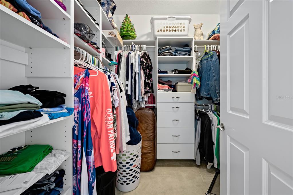 241 Riverside Drive, Unit 1909 Daytona Beach, FL 32117 - Photo 17 of 50 a view of walk in closet with clothes and shoes