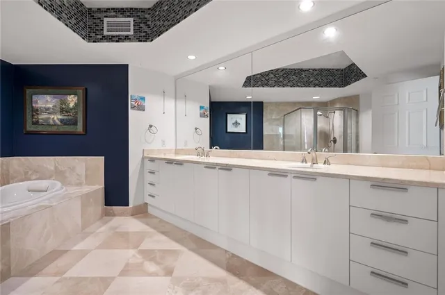 a spacious bathroom with a sink a large mirror and a bathtub