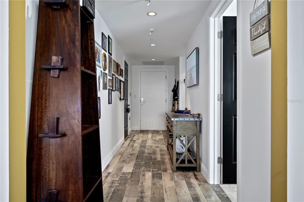 241 Riverside Drive, Unit 1909 Daytona Beach, FL 32117 - Photo 22 of 50 a view of a hallway with wooden floor and staircase