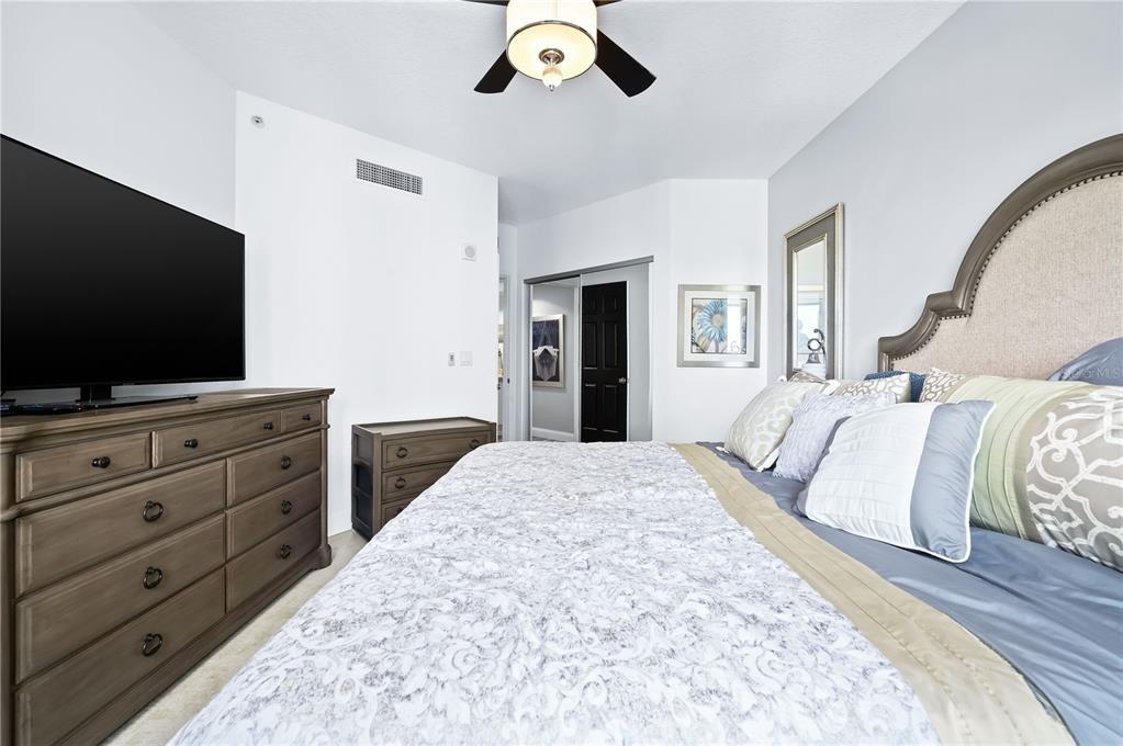 241 Riverside Drive, Unit 1909 Daytona Beach, FL 32117 - Photo 25 of 50 a bedroom with a large bed and a flat screen tv