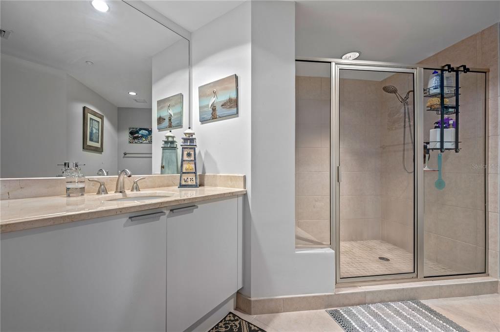 241 Riverside Drive, Unit 1909 Daytona Beach, FL 32117 - Photo 27 of 50 a bathroom with a shower sink and mirror