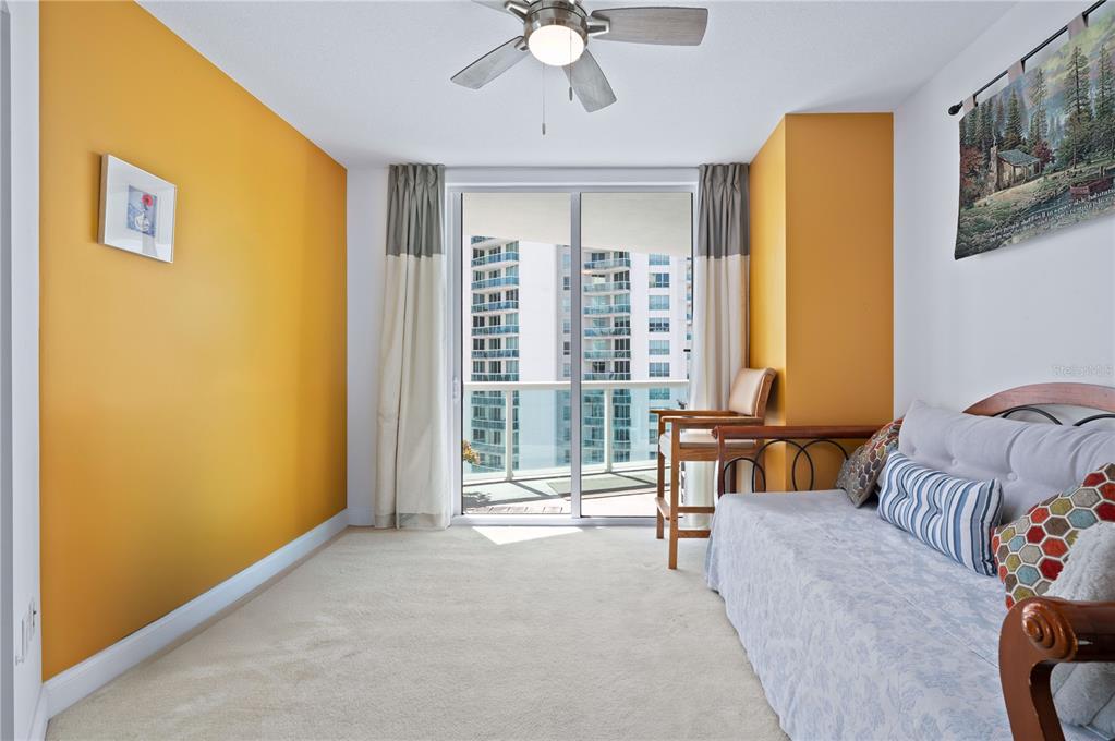 241 Riverside Drive, Unit 1909 Daytona Beach, FL 32117 - Photo 30 of 50 a bedroom with a bed and a window