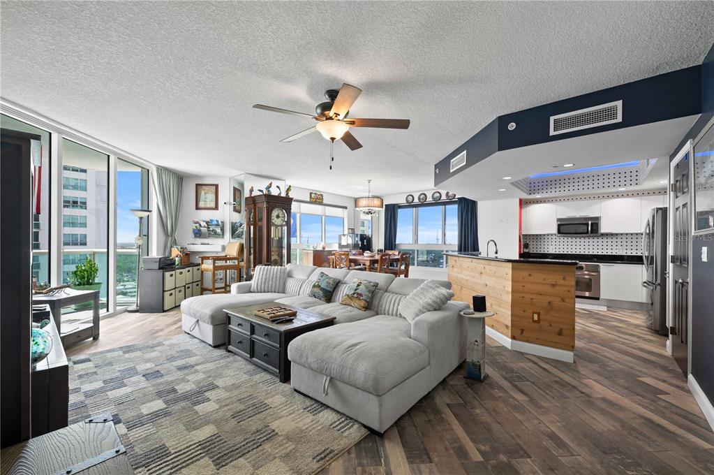 241 Riverside Drive, Unit 1909 Daytona Beach, FL 32117 - Photo 3 of 50 a living room with furniture kitchen view and a large window