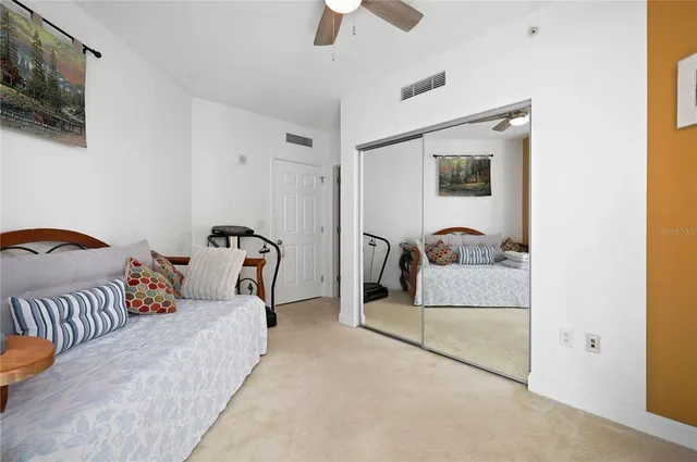 a bedroom with a bed and flat screen tv