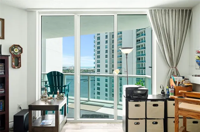 a view of a balcony with chairs and floor to ceiling window