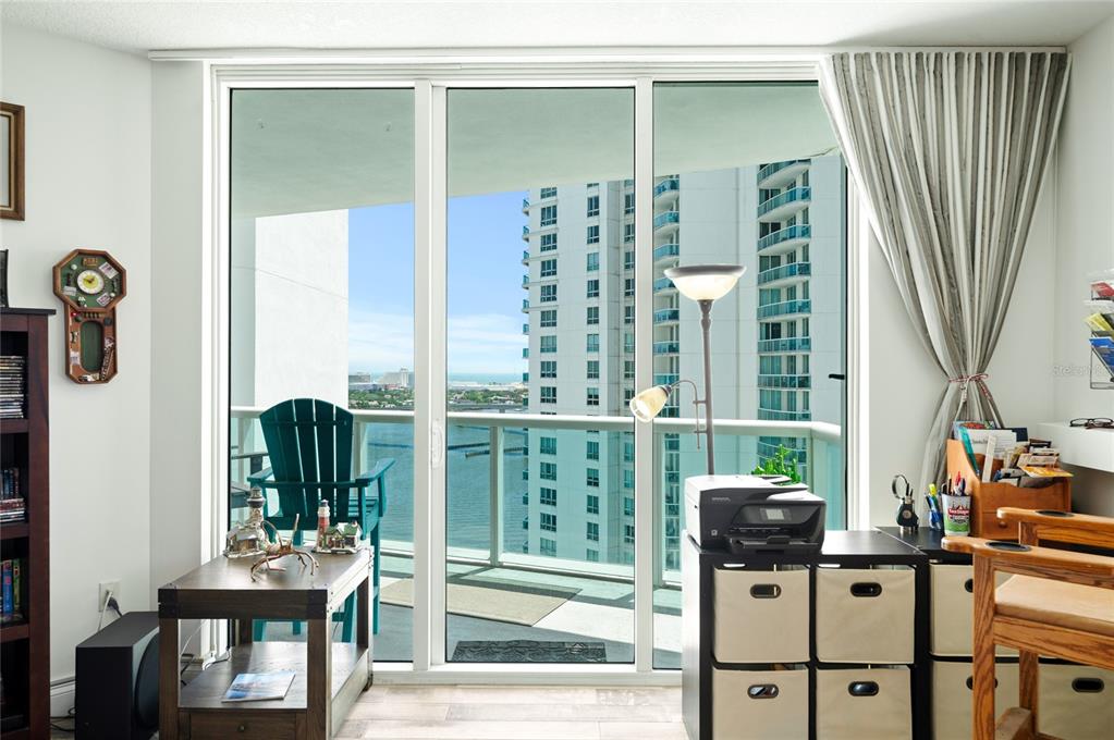 241 Riverside Drive, Unit 1909 Daytona Beach, FL 32117 - Photo 35 of 50 a view of a balcony with chairs and floor to ceiling window