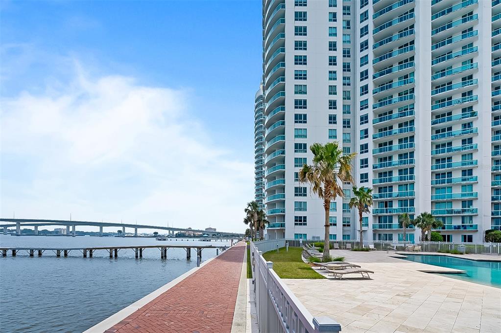 241 Riverside Drive, Unit 1909 Daytona Beach, FL 32117 - Photo 40 of 50 a view of swimming pool with lawn chairs and dinning table and chairs