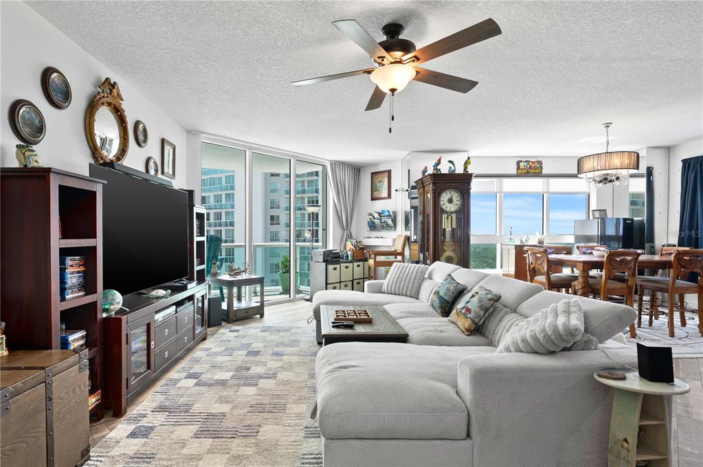 241 Riverside Drive, Unit 1909 Daytona Beach, FL 32117 - Photo 4 of 50 a living room with furniture and a flat screen tv