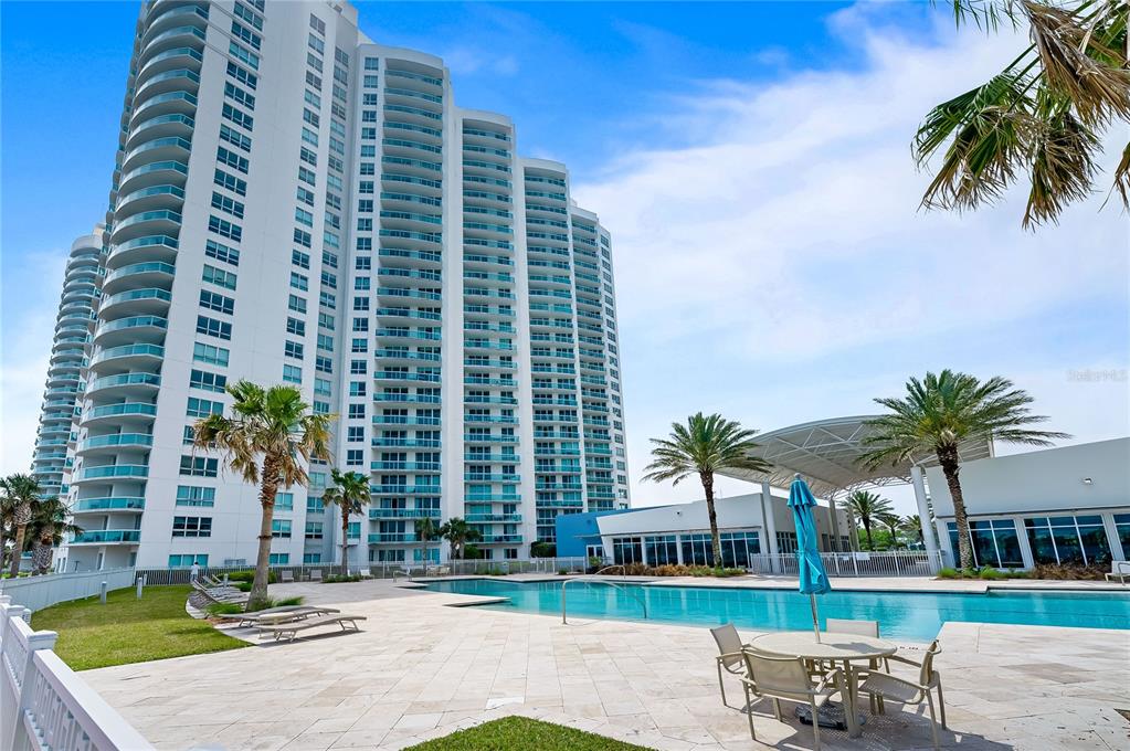 241 Riverside Drive, Unit 1909 Daytona Beach, FL 32117 - Photo 41 of 50 a chair and table sitting in front of a building