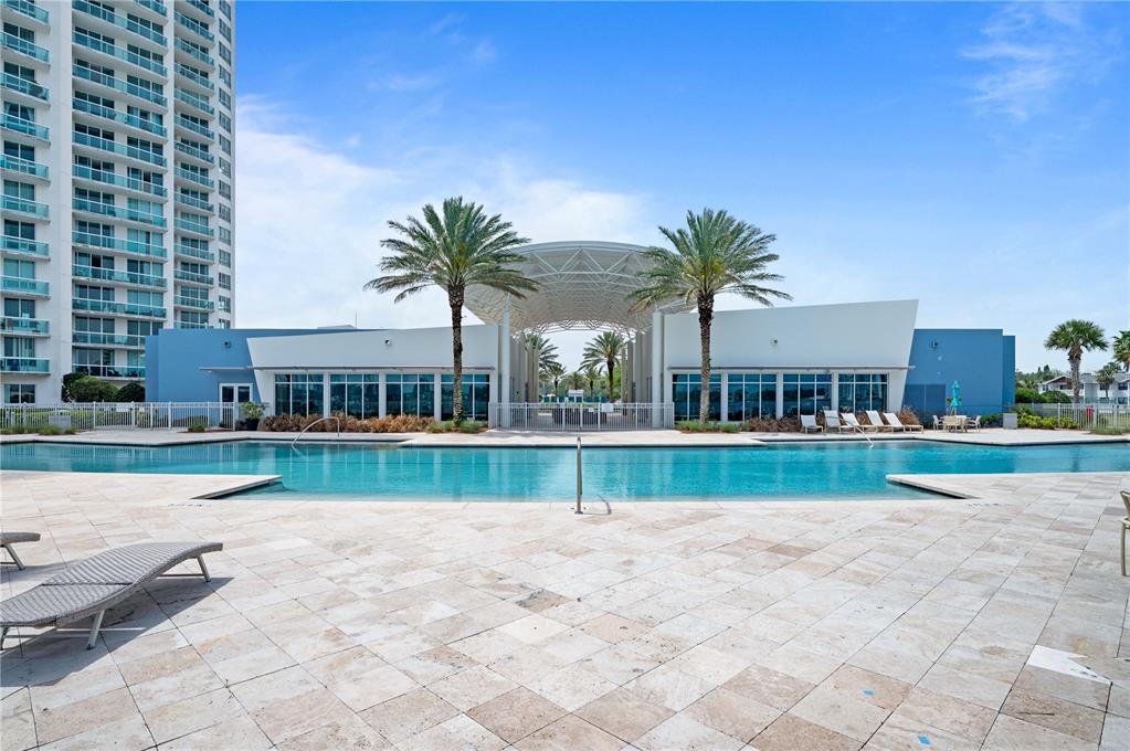 241 Riverside Drive, Unit 1909 Daytona Beach, FL 32117 - Photo 42 of 50 a view of house with swimming pool outdoor seating and house in the background