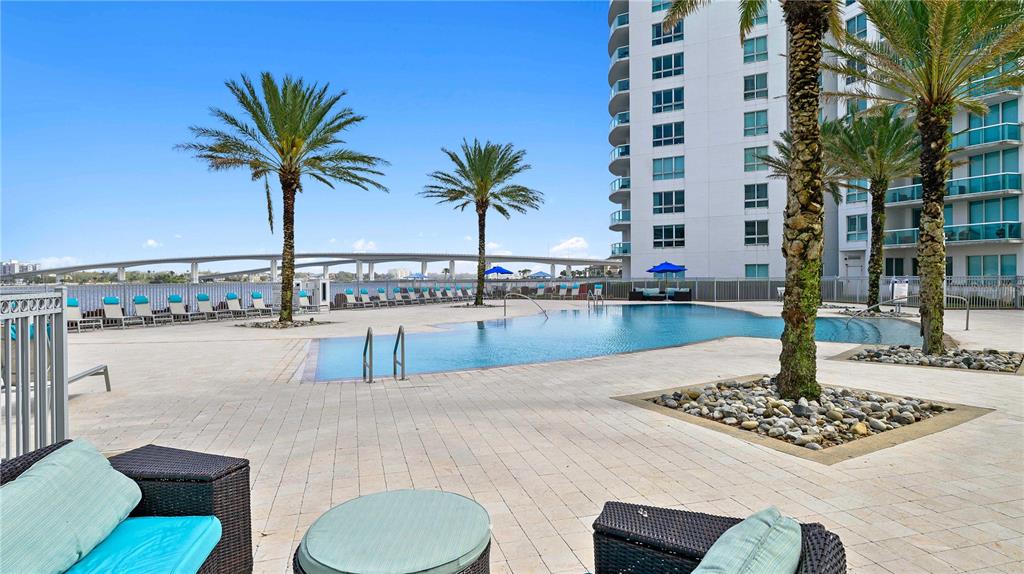 241 Riverside Drive, Unit 1909 Daytona Beach, FL 32117 - Photo 44 of 50 a swimming pool with a lawn chairs