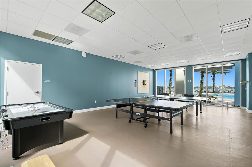 241 Riverside Drive, Unit 1909 Daytona Beach, FL 32117 - Photo 48 of 50 a kitchen with a table chairs and a stove
