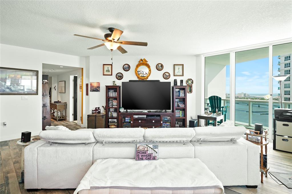 241 Riverside Drive, Unit 1909 Daytona Beach, FL 32117 - Photo 5 of 50 a living room with fireplace furniture and a flat screen tv