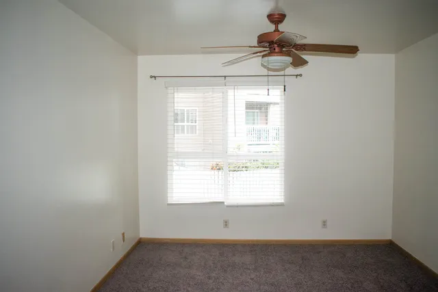 a room with a window and a ceiling fan