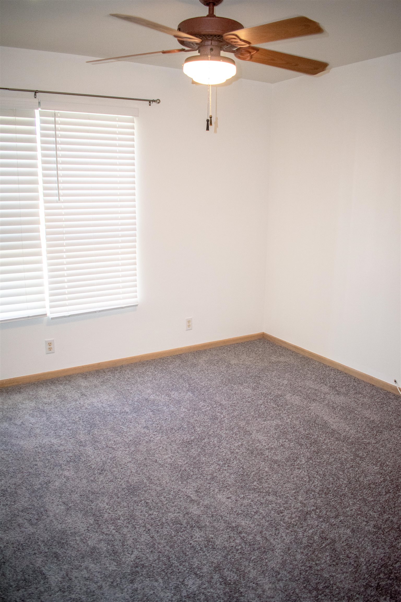 64 Kunihi Lane, Unit 324 Kahului, HI 96732 - Photo 23 of 31 an empty room with a window and a fan