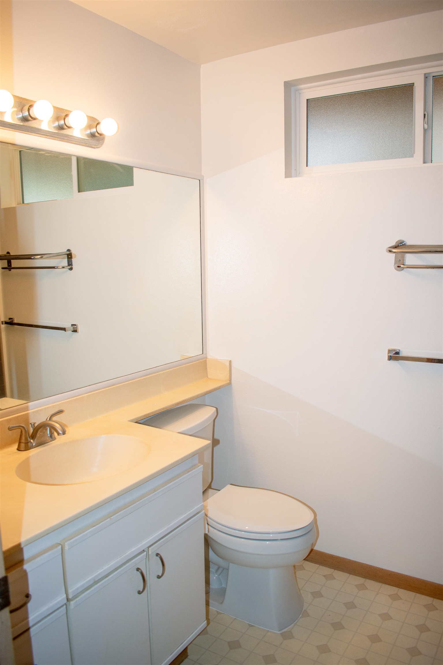 64 Kunihi Lane, Unit 324 Kahului, HI 96732 - Photo 27 of 31 a bathroom with a sink a toilet and vanity