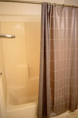 a view of a house with a yard and potted plants