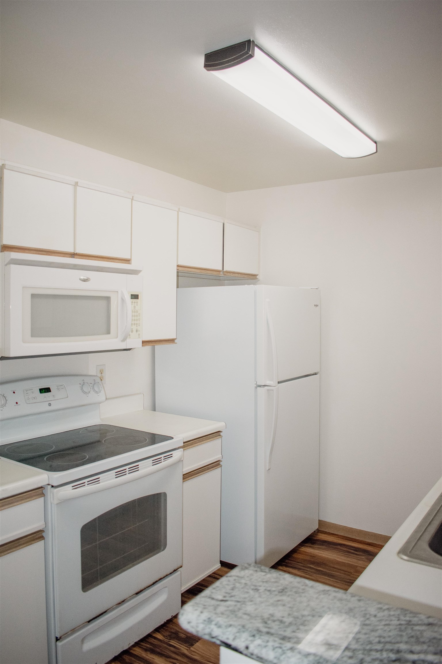 64 Kunihi Lane, Unit 324 Kahului, HI 96732 - Photo 5 of 31 a kitchen with a stove and a refrigerator