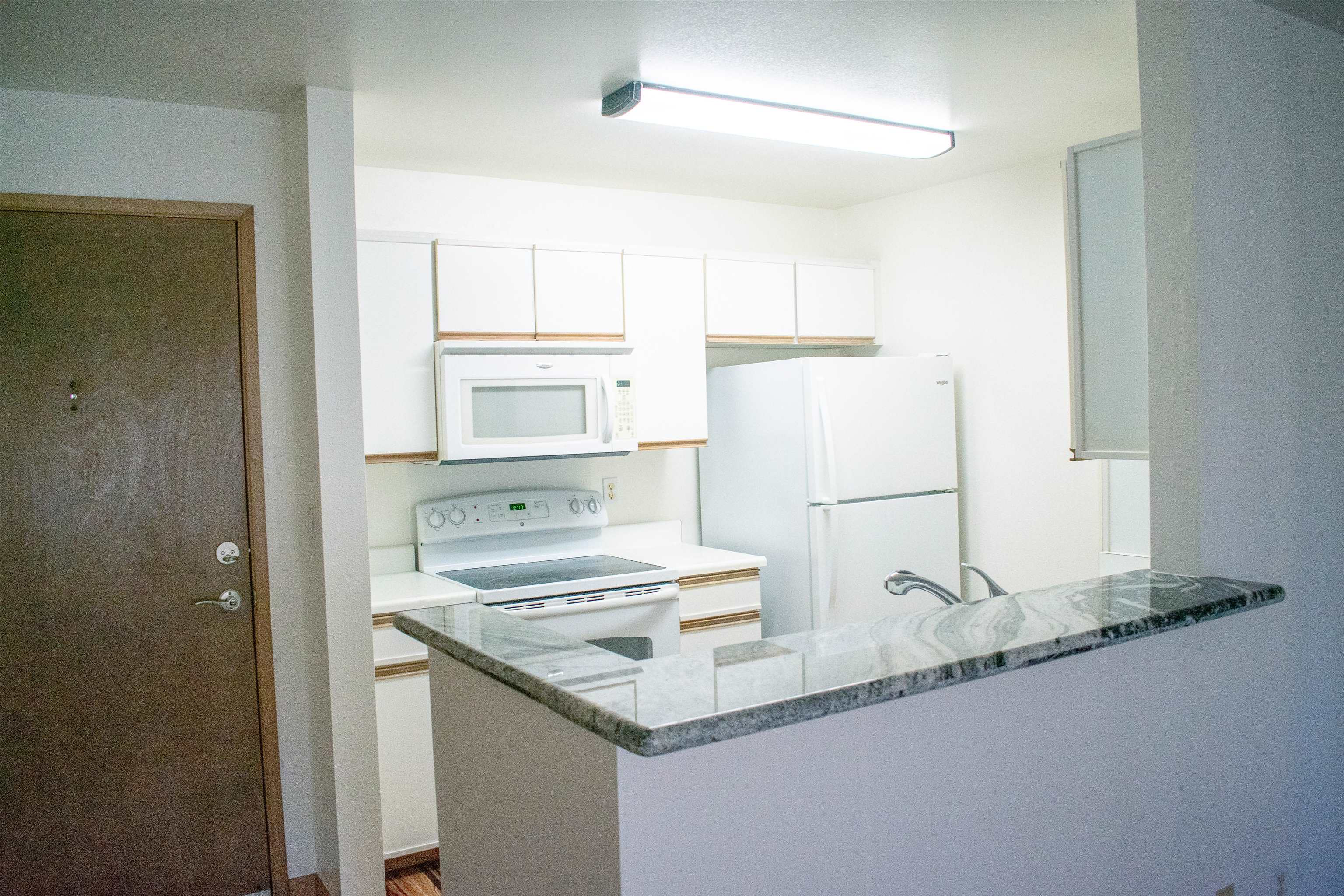 64 Kunihi Lane, Unit 324 Kahului, HI 96732 - Photo 7 of 31 a bathroom with a granite countertop sink and a mirror