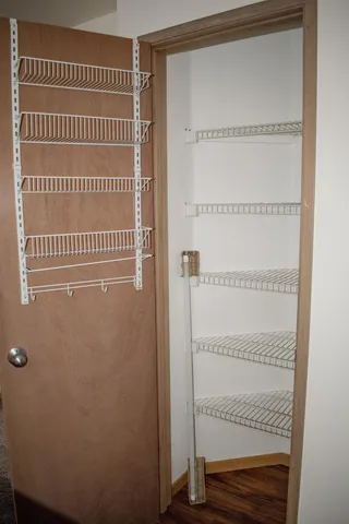 a view of a room with wooden floor