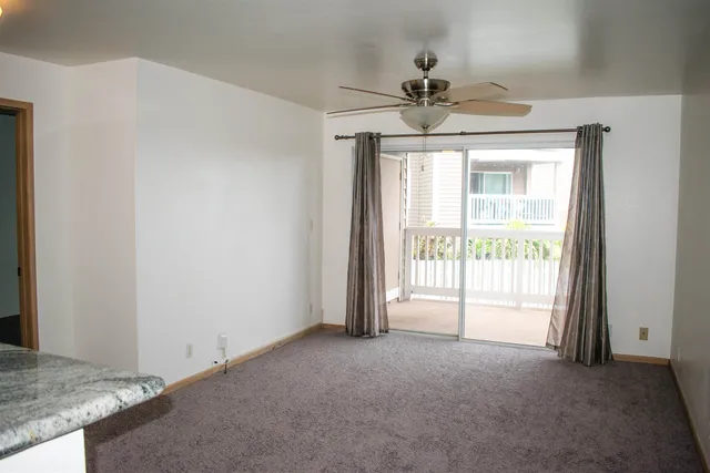 a view of a livingroom with a ceiling fan and window