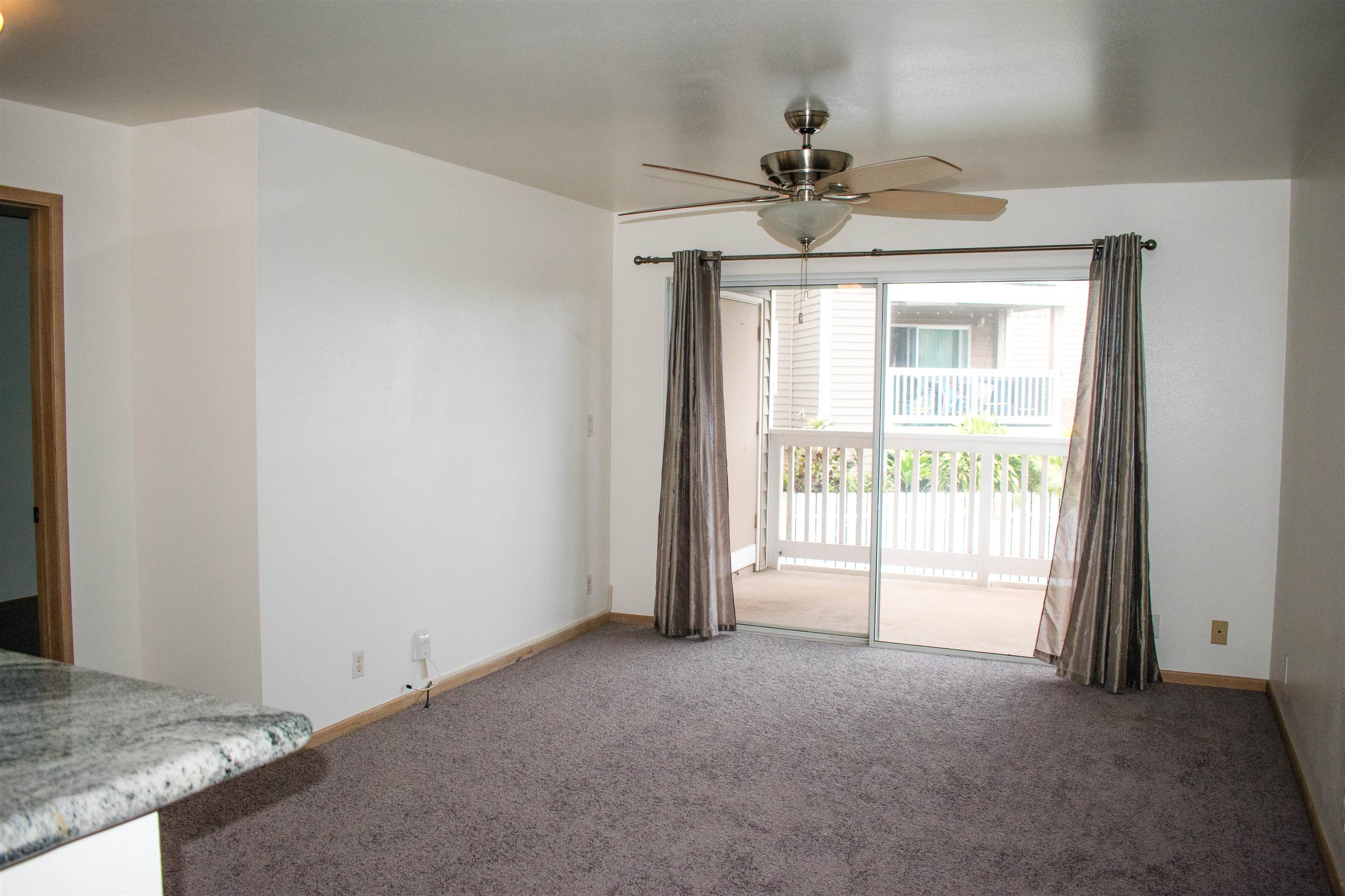 64 Kunihi Lane, Unit 324 Kahului, HI 96732 - Photo 10 of 31 a view of a livingroom with a ceiling fan and window