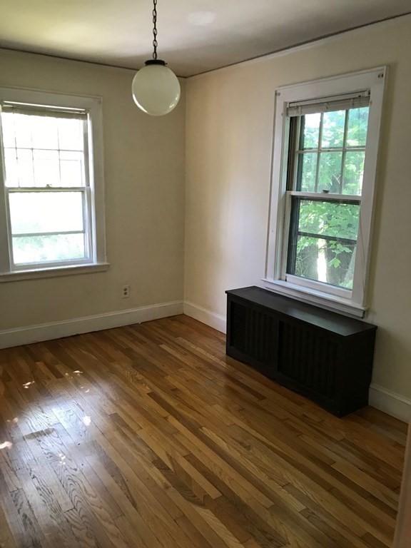 120 Lake Street Boston, MA 02135 - Photo 13 of 28 an empty room with wooden floor and windows