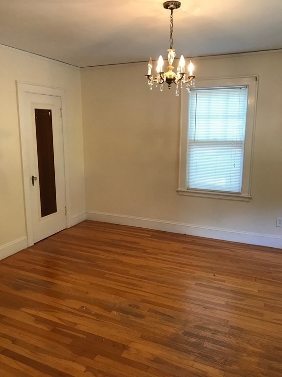 120 Lake Street Boston, MA 02135 - Photo 14 of 28 a view of a room with wooden floor and chandelier
