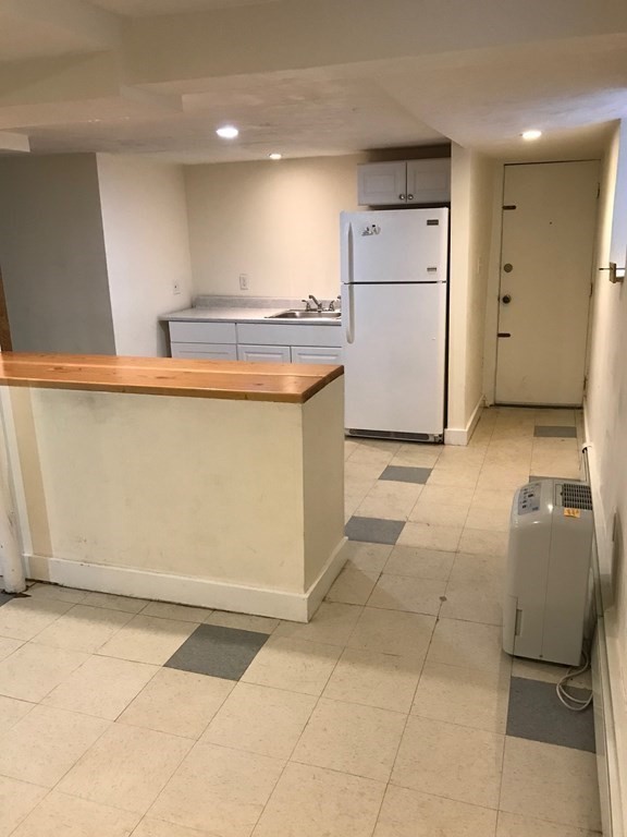 120 Lake Street Boston, MA 02135 - Photo 16 of 28 a kitchen with a sink a refrigerator and a stove