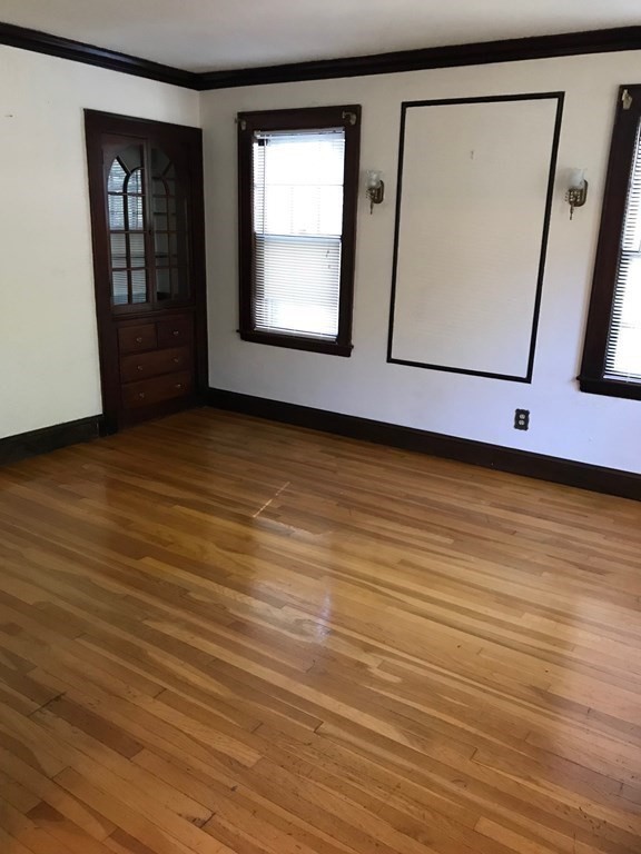 120 Lake Street Boston, MA 02135 - Photo 5 of 28 a view of an empty room with wooden floor and a window