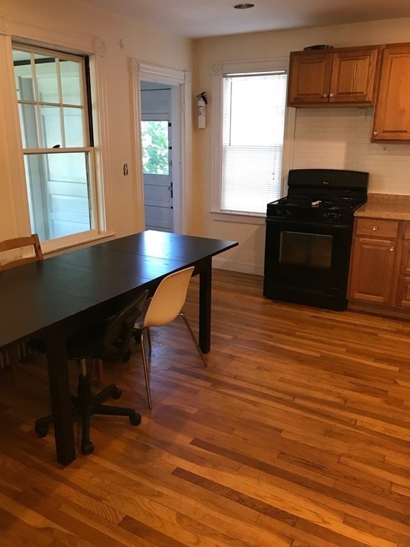 120 Lake Street Boston, MA 02135 - Photo 7 of 28 a living room with wooden floor table and a window