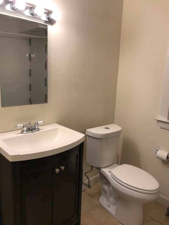 120 Lake Street Boston, MA 02135 - Photo 8 of 28 a bathroom with a sink a toilet and mirror