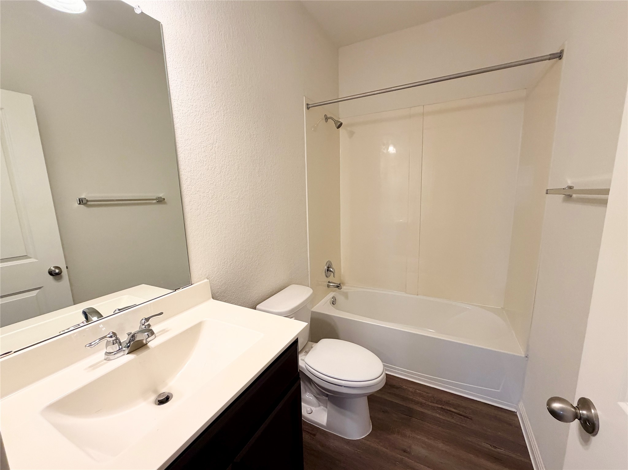 360 Bell Rings Drive Jarrell, TX 76537 - Photo 7 of 10 A well-appointed bathroom features a dark wood vanity, integrated sink, and modern fixtures.