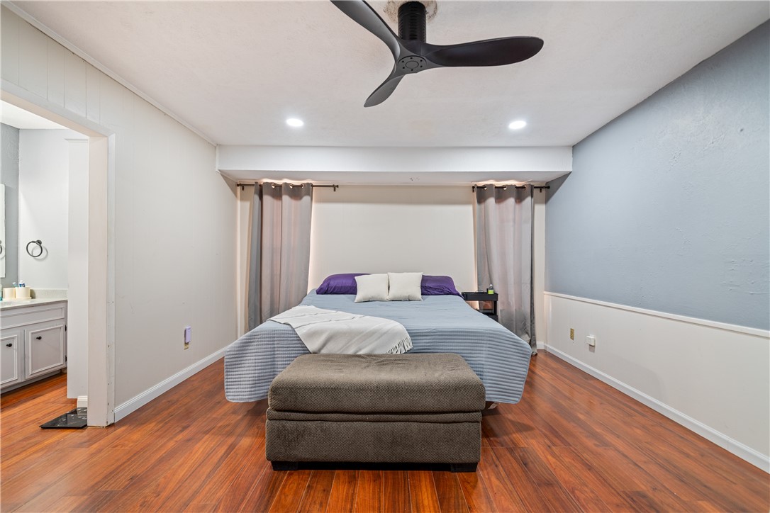 2217 Post Oak Drive Portland, TX 78374 - Photo 17 of 39 a bedroom with a bed and wooden floor