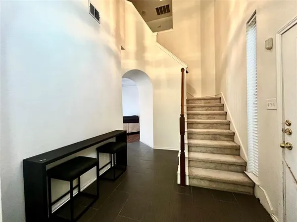 a living room with furniture and a large mirror