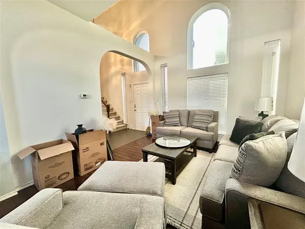 a living room with furniture and wooden floor