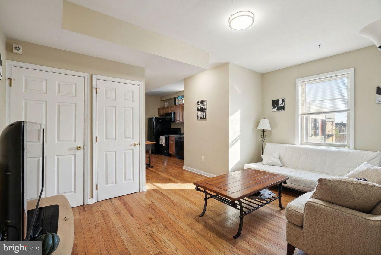 a living room with furniture a wooden floor and a window